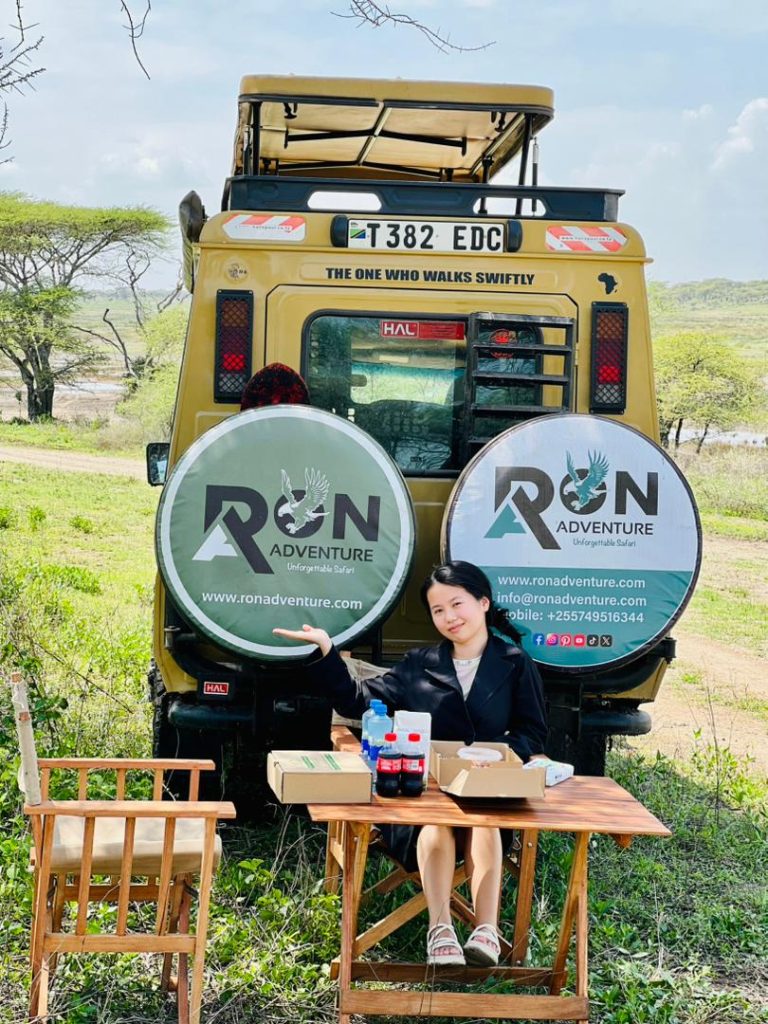 Tourists enjoying Tanzania safari holiday 2026 in open-roof 4x4”