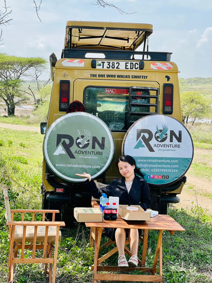 Clients reviewing a Tanzania safari itinerary with a local tour operator, illustrating how to choose the best safari company in Tanzania.” “Travelers talking with a trusted