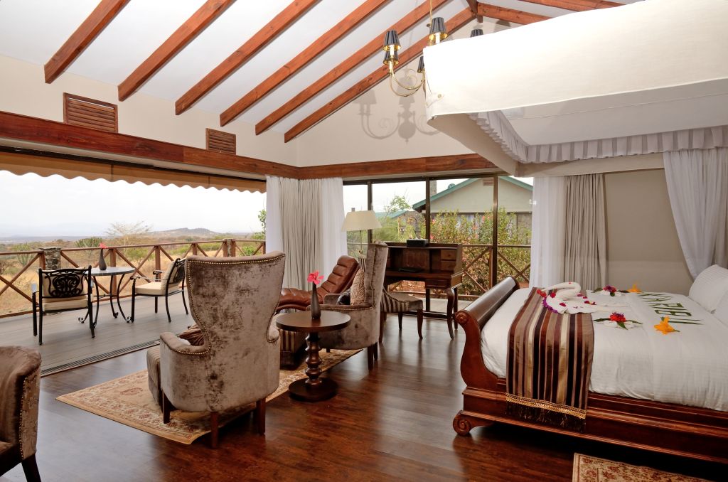 Luxury Tanzania safari accommodation overlooking Serengeti National Park with wildlife and premium safari lodge by Ron Adventure